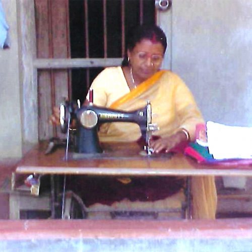 Woman sewing clothes for a living Woman sewing clothes for a living
